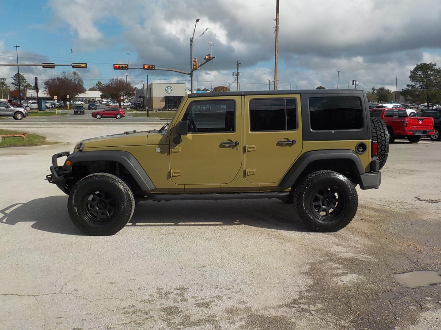 2011 Green Jeep Wrangler Unlimited Sport 4WD (1J4HA3H1XBL) with an 3.8L V6 OHV 12V engine, Automatic transmission, located at 1617 W Church Street, Livingston, TX, 77351, (936) 327-3600, 30.710995, -94.951157 - GOOD LOOKING JEEP!! WHEELS, TIRES, LIFT ALREADY! Good run and drive! - Photo#4